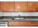 Kitchen sink with wooden cabinets and granite countertop at 2401 Havana Dr, Clearwater, FL 33764