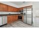 A cozy kitchen equipped with stainless steel appliances, wooden cabinets, and granite countertops at 2401 Havana Dr, Clearwater, FL 33764