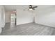 Bright living room featuring new gray vinyl flooring and a ceiling fan at 2401 Havana Dr, Clearwater, FL 33764