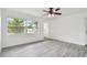 Bright living room featuring new gray vinyl flooring and a window for natural light at 2401 Havana Dr, Clearwater, FL 33764