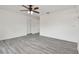 Bright living room featuring new gray vinyl flooring and a ceiling fan at 2401 Havana Dr, Clearwater, FL 33764