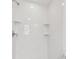 Bathroom shower with white tiles and built in shelf at 2401 Havana Dr, Clearwater, FL 33764