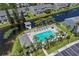Aerial view of community pool, lake, docks, and tropical landscaping at 273 Countryside Key Blvd, Oldsmar, FL 34677