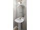 Powder room featuring a pedestal sink, arched mirror, and decorative wall sconce at 273 Countryside Key Blvd, Oldsmar, FL 34677