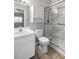 Bathroom featuring marble wall tiling in shower, white cabinets, and updated fixtures at 273 Countryside Key Blvd, Oldsmar, FL 34677