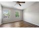 Bright bedroom with wood floors, ceiling fan and two windows offering natural light at 273 Countryside Key Blvd, Oldsmar, FL 34677