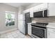Kitchen featuring white cabinets, stainless steel appliances, and tile flooring at 273 Countryside Key Blvd, Oldsmar, FL 34677