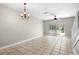 Open-plan living and dining space featuring tile floors and sliding glass doors to a patio at 273 Countryside Key Blvd, Oldsmar, FL 34677