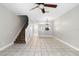 Open-plan living space featuring tile flooring, staircase, and a view of the dining room at 273 Countryside Key Blvd, Oldsmar, FL 34677