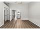 Main bedroom features wood-look floors, ceiling fan, and ensuite access to the bathroom at 273 Countryside Key Blvd, Oldsmar, FL 34677