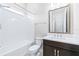 Bathroom features a tub and shower, large mirror and modern fixtures at 2819 Cordoba Ranch Blvd, Lutz, FL 33559