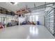 Spacious garage featuring epoxy floors, overhead storage, and a functional layout at 2819 Cordoba Ranch Blvd, Lutz, FL 33559