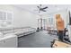 Spacious home gym area with rubber mat floors, modular sofa, ample equipment, and a neutral palette at 2819 Cordoba Ranch Blvd, Lutz, FL 33559