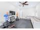 Home gym with grey rubber mat floor, modular sofa, mounted TV, weight rack, and punching dummy at 2819 Cordoba Ranch Blvd, Lutz, FL 33559