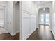 Bright hallway with wainscoting detail and hardwood flooring leading to the front door at 2819 Cordoba Ranch Blvd, Lutz, FL 33559