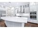 Bright, white kitchen with stainless appliances, subway tile backsplash, and large island at 2819 Cordoba Ranch Blvd, Lutz, FL 33559