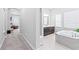 Primary bathroom with dark wood cabinetry, soaking tub, and natural light at 2819 Cordoba Ranch Blvd, Lutz, FL 33559