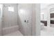 Tiled shower with bench, overhead shower, hand shower, and window in a renovated bathroom at 2819 Cordoba Ranch Blvd, Lutz, FL 33559