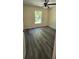 Cozy bedroom featuring luxury vinyl plank flooring, ceiling fan, and a window at 304 4Th Sw Ave, Largo, FL 33770