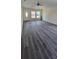 Spacious living room featuring luxury vinyl plank flooring, ceiling fan, and natural light at 304 4Th Sw Ave, Largo, FL 33770
