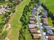 An aerial view of homes alongside a golf course, highlighting the lush fairways and manicured greens at 3148 Sago Point Ct, Land O Lakes, FL 34639