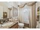 Well-lit bathroom with marble countertop and shower with curtain at 3148 Sago Point Ct, Land O Lakes, FL 34639