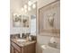 Bright bathroom with granite countertop, stylish mirror, and toilet at 3148 Sago Point Ct, Land O Lakes, FL 34639