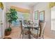 Dining room with window views and a decorative dining table set for four at 3148 Sago Point Ct, Land O Lakes, FL 34639