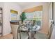 Dining room with glass table and decorative window with overhead valance at 3148 Sago Point Ct, Land O Lakes, FL 34639