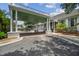 The clubhouse with a covered entrance, mature landscaping, and golf carts nearby at 3148 Sago Point Ct, Land O Lakes, FL 34639