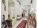 Bright foyer features tile floors, arched doorways, decorative accents, and views into other rooms at 3148 Sago Point Ct, Land O Lakes, FL 34639