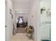 Hallway view with laundry room access and a glimpse of the office space beyond at 3148 Sago Point Ct, Land O Lakes, FL 34639