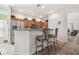 Modern kitchen with stainless steel appliances, granite countertops, breakfast bar, and wooden cabinets at 3148 Sago Point Ct, Land O Lakes, FL 34639