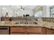 Close up of the kitchen sink and granite countertops in a bright open kitchen at 3148 Sago Point Ct, Land O Lakes, FL 34639