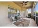 Screened lanai with ceiling fan, table and chairs with view of garden at 3148 Sago Point Ct, Land O Lakes, FL 34639