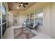 Screened lanai with table and chairs and view of backyard and garden at 3148 Sago Point Ct, Land O Lakes, FL 34639