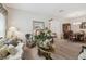 Cozy living space showcasing hardwood floors, stylish furniture, and access to the dining area at 3148 Sago Point Ct, Land O Lakes, FL 34639