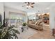 Inviting living space with hardwood floors, large windows, and a seamless flow into the kitchen area at 3148 Sago Point Ct, Land O Lakes, FL 34639