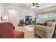 Cozy living area featuring a ceiling fan, window with blinds, and comfortable seating arrangements at 3148 Sago Point Ct, Land O Lakes, FL 34639