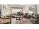 Elegant living room with hardwood floors, plush seating, and decorative floral window treatments at 3148 Sago Point Ct, Land O Lakes, FL 34639
