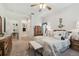 Spacious main bedroom with neutral colors, ceiling fan, carpeted floor and view to main bathroom at 3148 Sago Point Ct, Land O Lakes, FL 34639