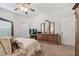 Spacious main bedroom with walk-out access and a dresser with a large mirror at 3148 Sago Point Ct, Land O Lakes, FL 34639
