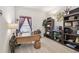 Well-lit home office featuring built-in bookshelves, a desk, and neutral carpeting at 3148 Sago Point Ct, Land O Lakes, FL 34639