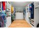 Spacious walk-in closet with custom shelving offers plenty of storage for clothes and accessories at 3434 Tarbolton Way, Land O Lakes, FL 34638