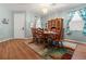 Formal dining room featuring wood floors, large dining table, and attractive chandelier lighting at 3434 Tarbolton Way, Land O Lakes, FL 34638
