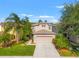 Inviting two-story home with well-manicured lawn and lush landscaping, offering great curb appeal at 3434 Tarbolton Way, Land O Lakes, FL 34638