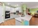 Modern kitchen with white cabinets, quartz countertops, and stainless steel appliances offers style and functionality at 3434 Tarbolton Way, Land O Lakes, FL 34638