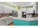 Modern kitchen with stainless steel appliances, breakfast bar, and white cabinetry at 3434 Tarbolton Way, Land O Lakes, FL 34638