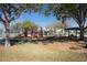 Neighborhood playground with various play structures surrounded by mature trees and a picnic shelter at 3434 Tarbolton Way, Land O Lakes, FL 34638