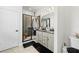 Modern bathroom featuring a glass-enclosed shower, double vanity, and stylish fixtures at 37587 Mackenzie Dr, Zephyrhills, FL 33540